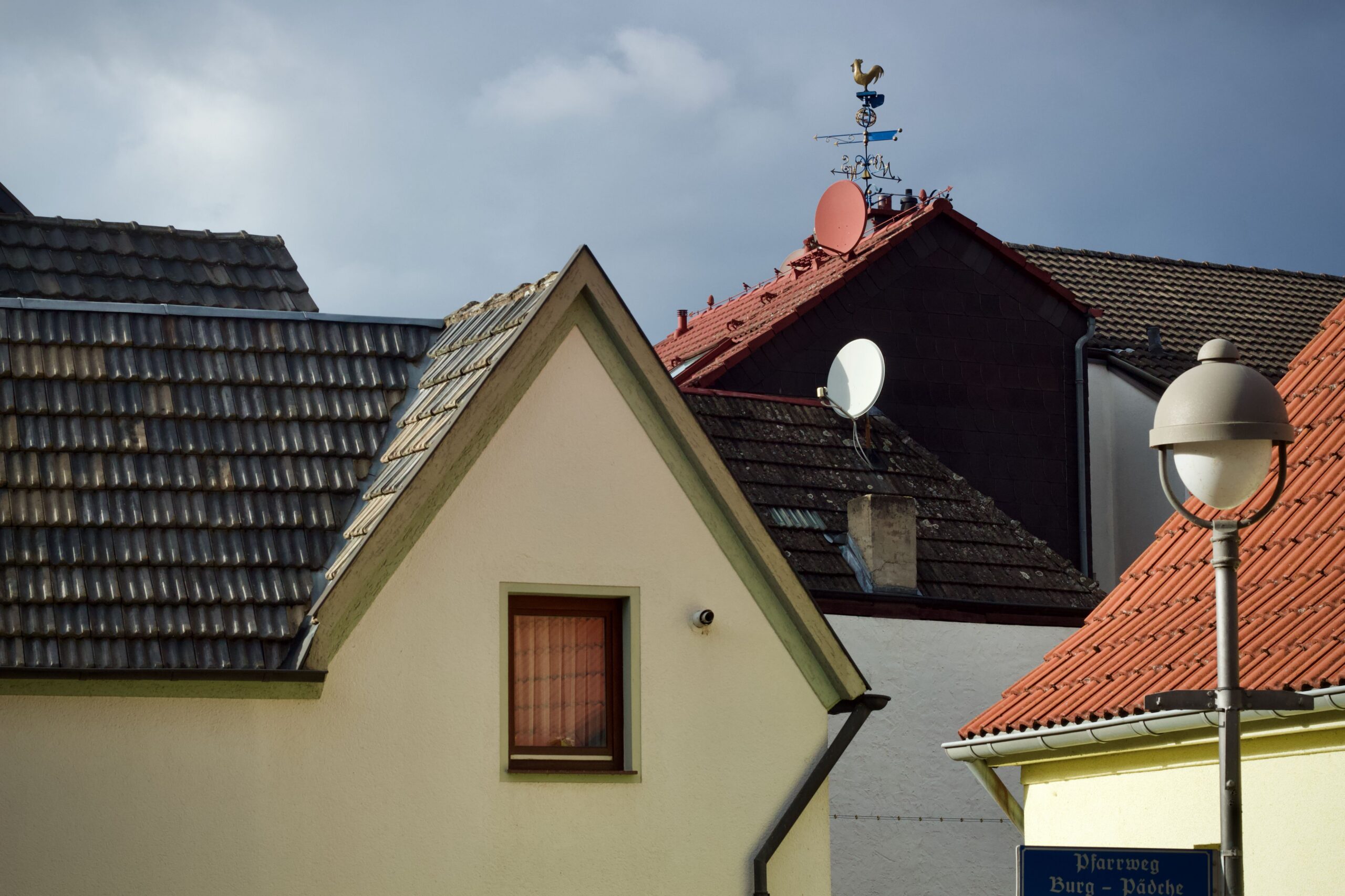 Scenic view of European rooftops featuring satellite dishes and classic architecture.
